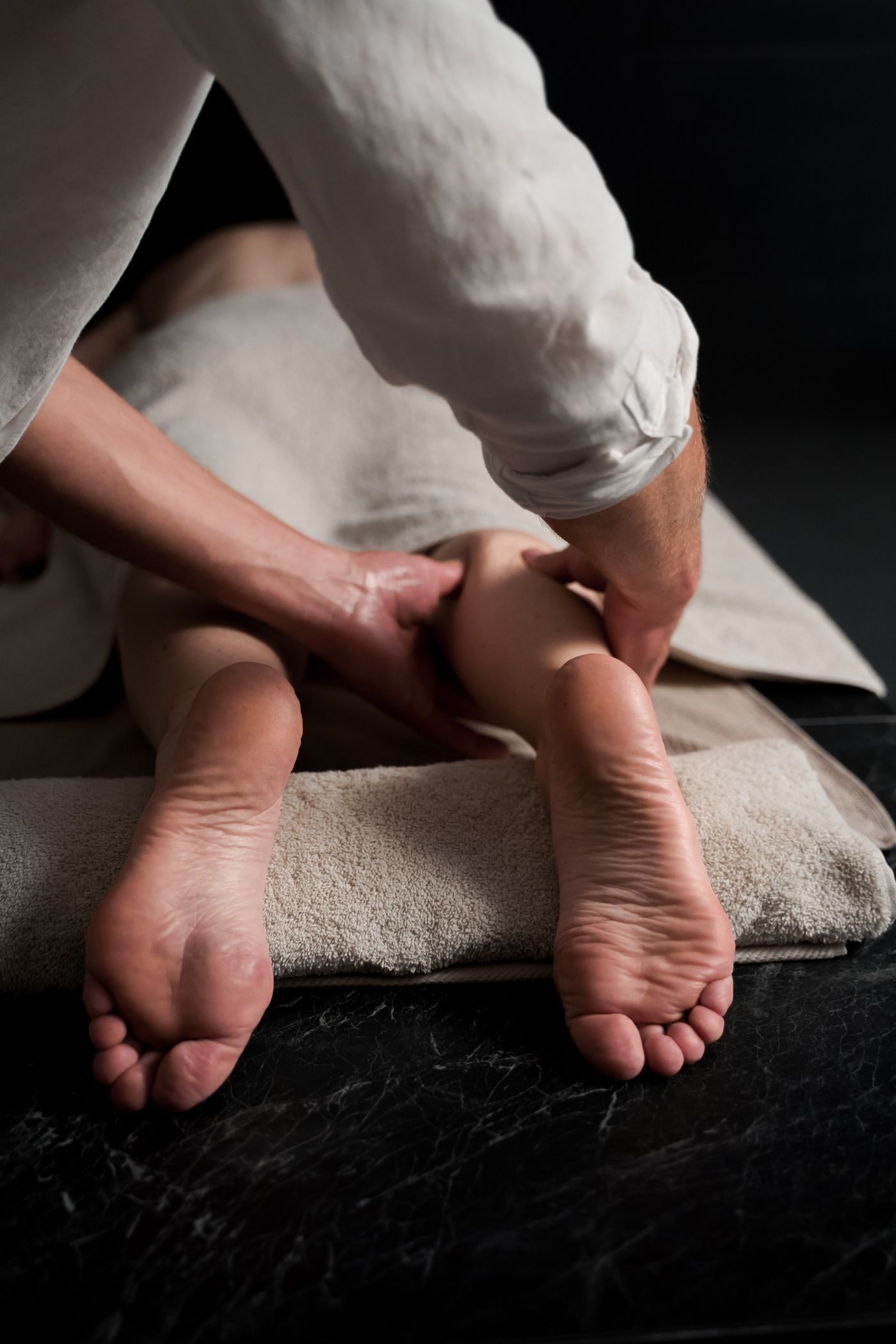 A therapist gives the client a foot massage